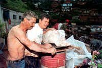 Caracas. 09.08.93,Venezuela 
Un joven llora al lado del cadaver cubierto de su madre,que murio tras ser tapiada su vivienda por un derrumbe producido por la lluvia caida por el coletazo de la torment